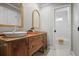 Bathroom with double sinks and vintage-inspired wooden vanity, plus tub/shower at 1050 Willeo Ct, Marietta, GA 30068