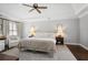 Bright bedroom featuring a ceiling fan, a cozy bed, and a patterned rug at 1050 Willeo Ct, Marietta, GA 30068