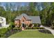 Stately brick home with a well-manicured lawn and lush landscaping at 1050 Willeo Ct, Marietta, GA 30068