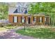 Charming brick home with black shutters, landscaping, and brick walkway at 1050 Willeo Ct, Marietta, GA 30068