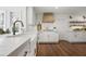 Charming kitchen with white cabinets, hardwood floors, and stone countertops at 1050 Willeo Ct, Marietta, GA 30068