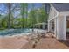 Home exterior featuring an in-ground pool, covered patio, and stone fireplace at 1050 Willeo Ct, Marietta, GA 30068