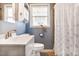Bathroom with sink, toilet and shower with window that lets in natural light at 1400 Hidden Circle Dr, Sugar Hill, GA 30518