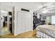 Bedroom featuring hardwood floors and closet with organized shelving at 1400 Hidden Circle Dr, Sugar Hill, GA 30518