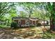 Charming home exterior with well-maintained lawn and flowering bushes at 1400 Hidden Circle Dr, Sugar Hill, GA 30518