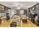 Open living area with hardwood floors, vintage furniture, and abundant eclectic art at 1400 Hidden Circle Dr, Sugar Hill, GA 30518