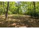 Lush backyard with a mix of manicured lawn and trees at 1740 Fairbanks Sw St, Atlanta, GA 30310