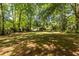 Spacious backyard featuring green grass and distant home at 1740 Fairbanks Sw St, Atlanta, GA 30310