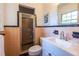 Vintage bathroom featuring peach tile, a shower, a white vanity, and a bright window at 1740 Fairbanks Sw St, Atlanta, GA 30310