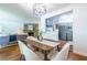 Open concept floor plan featuring a dining table with seating for six, connecting to a living room and kitchen at 1740 Fairbanks Sw St, Atlanta, GA 30310