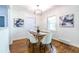Dining room with hardwood floors, overhead lighting, and natural light from a large window at 1740 Fairbanks Sw St, Atlanta, GA 30310