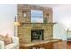 Detailed view of a stone fireplace with decorative elements, hardwood floors, and a cozy ambiance, highlighting design at 1740 Fairbanks Sw St, Atlanta, GA 30310