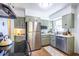Charming kitchen featuring sage cabinetry, stainless steel appliances, and a bright window at 1740 Fairbanks Sw St, Atlanta, GA 30310