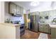 Kitchen with stainless steel appliances, sage green cabinetry, and tile floors at 1740 Fairbanks Sw St, Atlanta, GA 30310