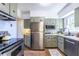 Charming kitchen featuring sage cabinetry, stainless steel appliances, and a bright window at 1740 Fairbanks Sw St, Atlanta, GA 30310