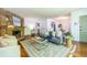 Bright living room featuring a stone fireplace, hardwood floors, stylish furniture, and an open floor plan at 1740 Fairbanks Sw St, Atlanta, GA 30310