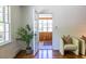 Bright living room with hardwood floors, white walls, and doorway to a sunroom with lots of natural light at 1740 Fairbanks Sw St, Atlanta, GA 30310