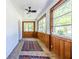 Inviting sunroom with lots of windows, wood-paneled walls and a ceiling fan at 1740 Fairbanks Sw St, Atlanta, GA 30310