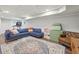 Spacious finished basement with a blue sectional, area rug, and recreational area at 2789 Townley Cir, Atlanta, GA 30340