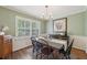 Inviting dining room featuring a classic table, updated lighting, and natural light streaming through shuttered windows at 2789 Townley Cir, Atlanta, GA 30340