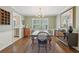 Elegant dining room showcasing hardwood floors, wainscoting, a modern light fixture, and a view into the kitchen at 2789 Townley Cir, Atlanta, GA 30340