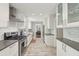 Modern kitchen with stainless steel appliances, white cabinets, subway tile backsplash, and durable light-toned flooring at 2789 Townley Cir, Atlanta, GA 30340