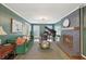 Elegant living room featuring a grand piano, fireplace, plush green sofa, and sophisticated decor at 2789 Townley Cir, Atlanta, GA 30340