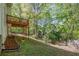 Backyard featuring a lush lawn and a deck overlooking the serene wooded landscape at 5108 Staplehurst Ln, Woodstock, GA 30189