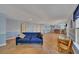 Open basement featuring wood-look floors, blue walls, and a bar with stools for entertaining at 5108 Staplehurst Ln, Woodstock, GA 30189