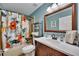 A bathroom features a combination tub and shower with floral curtains and a dark wood vanity at 5108 Staplehurst Ln, Woodstock, GA 30189