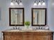 A bathroom featuring a double sink vanity with granite countertops and dark wood cabinetry at 5108 Staplehurst Ln, Woodstock, GA 30189