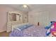 A lovely bedroom featuring a plush carpet, a ceiling fan, and a dresser with a mirror at 5108 Staplehurst Ln, Woodstock, GA 30189