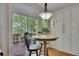 Bright breakfast nook featuring a round table, chairs, and a view of the outdoor deck at 5108 Staplehurst Ln, Woodstock, GA 30189
