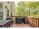 Spacious deck with wood railing, featuring grilling area with multiple covered grills at 5108 Staplehurst Ln, Woodstock, GA 30189