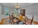 Dining room with traditional furniture, a large window, and an ornate chandelier at 5108 Staplehurst Ln, Woodstock, GA 30189
