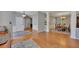 Open foyer and formal dining area with hardwood floors, elegant lighting, and neutral paint at 5108 Staplehurst Ln, Woodstock, GA 30189