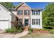 Close up of a home's front entrance featuring a brick walkway and lush plantings at 5108 Staplehurst Ln, Woodstock, GA 30189