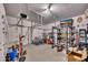 Spacious garage with overhead storage racks, room for multiple bikes, and gym equipment at 5108 Staplehurst Ln, Woodstock, GA 30189