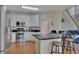 Modern kitchen with stainless steel appliances, white cabinets, and breakfast bar with seating at 5108 Staplehurst Ln, Woodstock, GA 30189