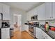 Well-equipped kitchen with granite countertops, stainless steel appliances, and ample cabinet space at 5108 Staplehurst Ln, Woodstock, GA 30189
