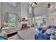Bright, open living room with a fireplace, large windows, and stairs leading to upper level at 5108 Staplehurst Ln, Woodstock, GA 30189