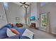 Bright living room featuring high ceilings, large windows, and a cozy fireplace with a mantel at 5108 Staplehurst Ln, Woodstock, GA 30189