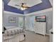 Spacious main bedroom with tray ceiling, dresser, and ensuite bathroom access at 5108 Staplehurst Ln, Woodstock, GA 30189