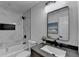 This bathroom features black hardware, marble tiling, and a shower with tub combo at 538 Center Hill Nw Ave, Atlanta, GA 30318