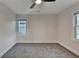 This bedroom features carpet flooring, fresh paint, 2 windows and a ceiling fan at 538 Center Hill Nw Ave, Atlanta, GA 30318