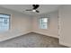 This bedroom features carpet flooring, fresh paint, 2 windows and a ceiling fan at 538 Center Hill Nw Ave, Atlanta, GA 30318