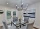 Dining room view with modern chandelier, seating for four, and patio access at 538 Center Hill Nw Ave, Atlanta, GA 30318