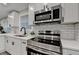 Close-up of a kitchen featuring stainless steel appliances and white subway tile backsplash at 538 Center Hill Nw Ave, Atlanta, GA 30318