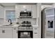 Modern kitchen with white cabinets, stainless appliances, and subway backsplash at 538 Center Hill Nw Ave, Atlanta, GA 30318