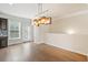 Bright dining area with hardwood floors and modern lighting fixtures near the kitchen at 6404 Brookside Se Blvd, Mableton, GA 30126